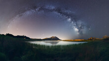A Beautiful Landscape View Of Half Cloudy Circle On  Reflecting On Water At Night