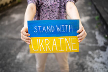 Demonstrator Holding "Stand With Ukraine" Placard