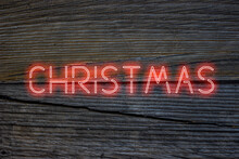 Neon Christmas Lettering On Wooden Surface