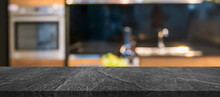 Black Marble Stone Counter Top With Blurred Kitchen Interior Background