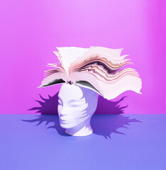 Wall Mural - Human head with open book on blue and purple background. Surreal, education, study and knowledge concept