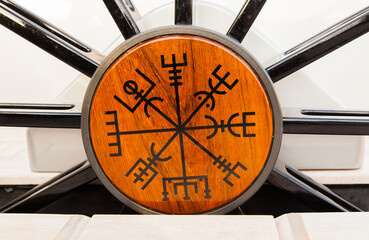 Unusual scandinavian symbols and signs on the helm of a sailing yacht. Viking runes on a sailing yacht.