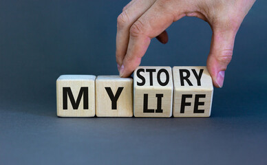 Fototapete - Story of my life symbol. Businessman turns wooden cubes and changes concept words My story to My life. Beautiful grey table grey background. Business story of my life concept. Copy space.