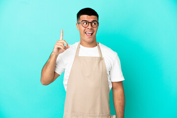 Poster - Restaurant waiter man over isolated blue background intending to realizes the solution while lifting a finger up