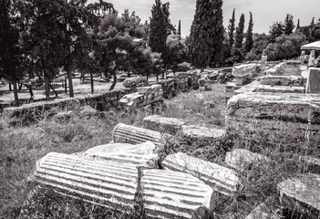 Wall Mural - Ancient Greek ruins at Acropolis foot, Athens, Greece, Europe. Black and white photo.