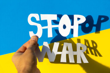 Stop war, conflict between Ukraine and Russia. Hands of a man holding a symbol to stop the war