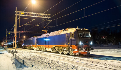 Wall Mural - Heavy iron ore train at Abisko in Swedish Lapland in winter