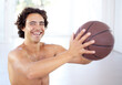 © Stephen L/peopleimages.com - Getting ready to hit the courts. Portrait of a sexy young man holding a basketball.
