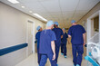 © D Laflor/peopleimages.com - Working in the hospital. Rearview shot of a medical team standing in a hospital.