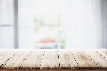 Wall Mural - blur wooden table in the kitchen on the window background in the morning..