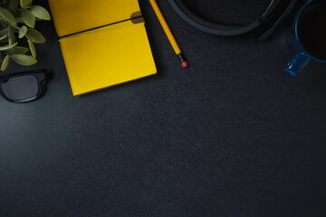 Poster - top view working desk notebook,headphone and coffee cup on black table background