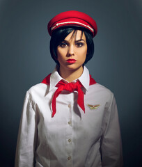 Wall Mural - All aboard. Studio portrait of a woman dressed in a retro flight attendant uniform.