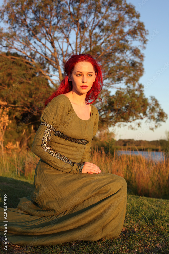 Full length portrait of red haired woman wearing a beautiful green ...