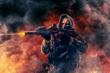 Wall Mural - Modern army soldier with hood shooting against fire