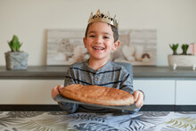 Young Boy In Front Of A King Cake