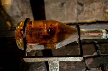 Sparkling wine production by traditional methods in underground cellars in Vienna, Austria. Sediment in bottle.