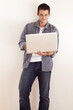 © Anne B/peopleimages.com - Accessing the internet from anywhere. A handsome young man working on his laptop.