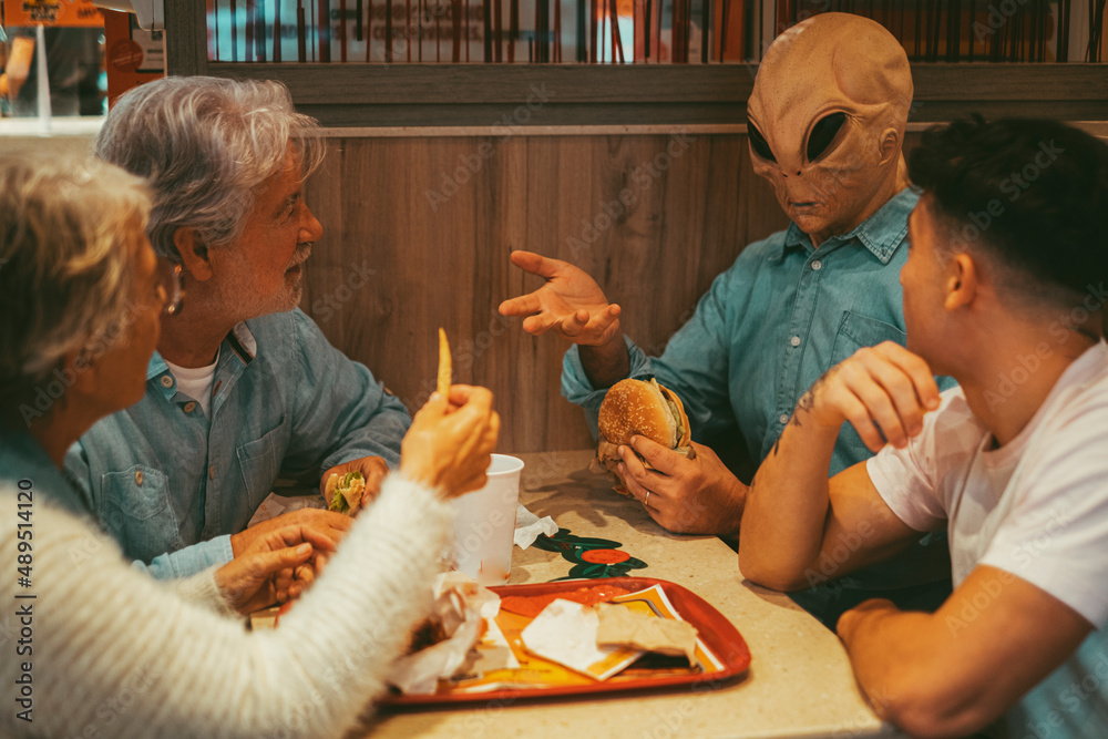 Happy family with ufo alien estraterrestrial guest enjoy together 