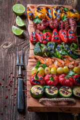 Wall Mural - Healthy grilled skewer made of mediterranean seafood and vegetables.