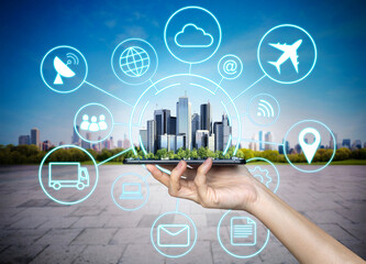 Poster - Hand holding mobile smart phone with modern buildings. Smart city, 5g, internet and networking technology concept