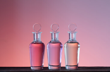 Wall Mural - bottles with magic potions on pink background