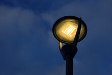 Glowing Led Lamp On Background Of Evening Sky. Electric Lighting, Energy-saving Street Lantern