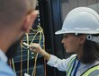 © Siphosethu F/peopleimages.com - Gotta get this right. Shot of two workers inspecting the electronic equipment in a server room together at work.