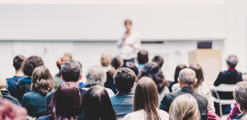 woman giving presentation on business conference.