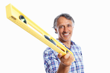 Canvas Print - Smiling architect holding spirit-level. Portrait of smiling mature architect holding spirit-level over white background.