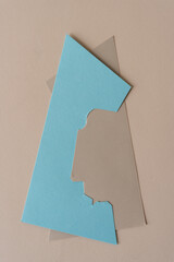 two paper shapes on a paper surface