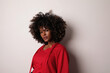 © face_reader_img - African American woman with curly hair wearing red top over white background.