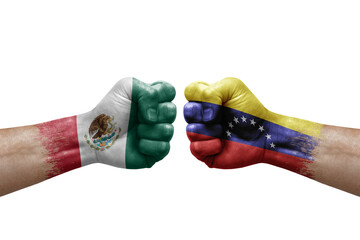 Two hands punch to each others on white background. Country flags painted fists, conflict crisis concept between mexico and venezuela