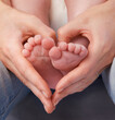 © Tabitha R/peopleimages.com - Loving the little things. Cropped shot of a mothers hands making a heart shape around her babys feet.