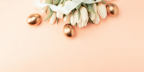 Wall Mural - Golden eggs with spring white tulips on pastel pink background in Happy Easter decoration. Foil minimalist egg design, modern top view banner design.