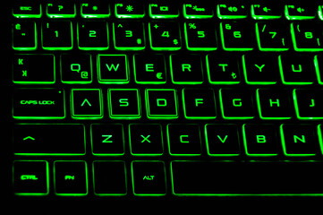 A black color laptop and Q keyboard green light detail