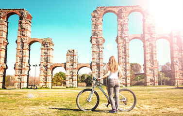 Wall Mural - Merida,  Aqueduct de los Milagros- woman traveling by bike