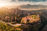 Fototapeta Natura - Panoramic majestic aerial view of the famous Meteora flying monasteries in Greece at sunrise. Travel to the wonders of the world. Visit travel attractions and landmarks