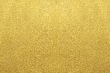 gold wall texture background. yellow shiny gold paint on concrete wall surface