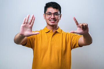 Wall Mural - Asian young man showing and pointing up with fingers number seven