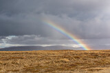 Fototapeta Tęcza - Scenery with dark clouds and rainbow over the raw coast of Snaefellsnes peninsula, Iceland