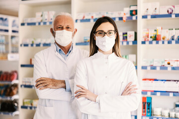 Wall Mural - Multigenerational apothecary workers posing at pharmacy during covid 19.