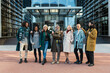 © Jordi Mora - Group of modern businessmen and women outside building posing happily and having good time