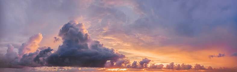 beautiful lilac clouds on the sky panorama and purple orange sunset