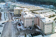 Russia, Krasnoyarsk, February 19, 2022: New residential complex incom pines, elite residential area, houses and townhouses on the riverbank at the foot of the mountains in Siberia near the taiga