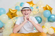 © Ольга Анатольевна - birthday boy in a hat on the background of balloons