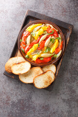 Wall Mural - Escalivada or escalibada Spanish traditional dish of smoky grilled vegetables closeup in the wooden board on the table. Vertical top view from above