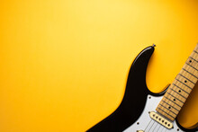 Electric Guitar Body Close Up With Bright Yellow Background, Overhead, Musical Banner Picture.