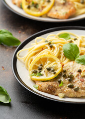 Chicken Piccata with capers, white wine sauce and spaghetti. Italian food