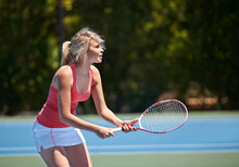 Ready To Win. A Tennis Player With Her Tennis Racket On A Tennis Court.