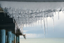 Icicles With Blue Sky And Sea Background